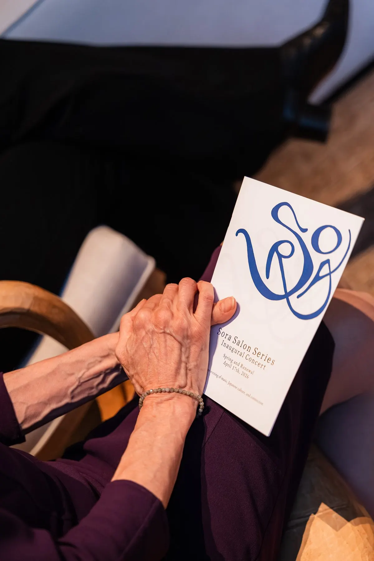 A guest’s hands holding the program during the concert