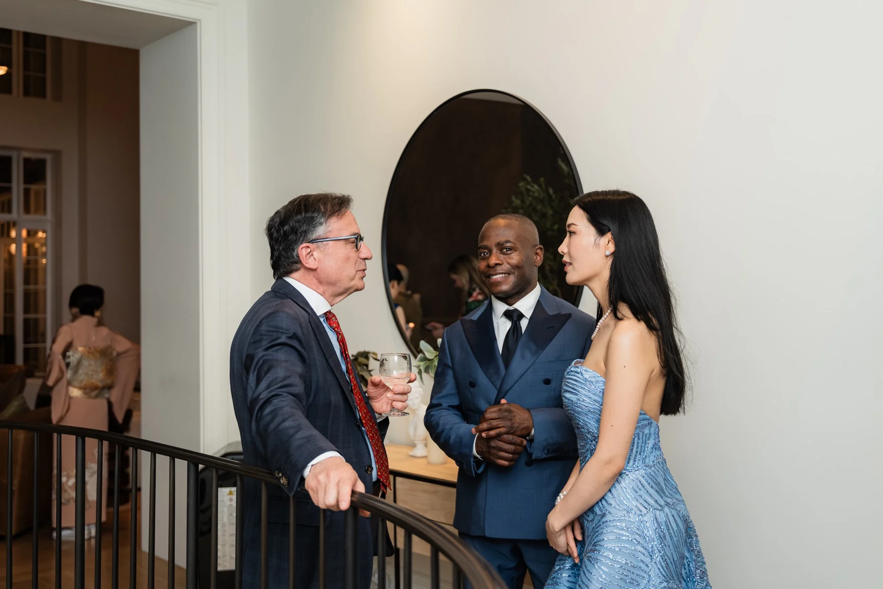 Rieko Tsuchida and Anthony McGill talking with a guest on the townhouse landing
