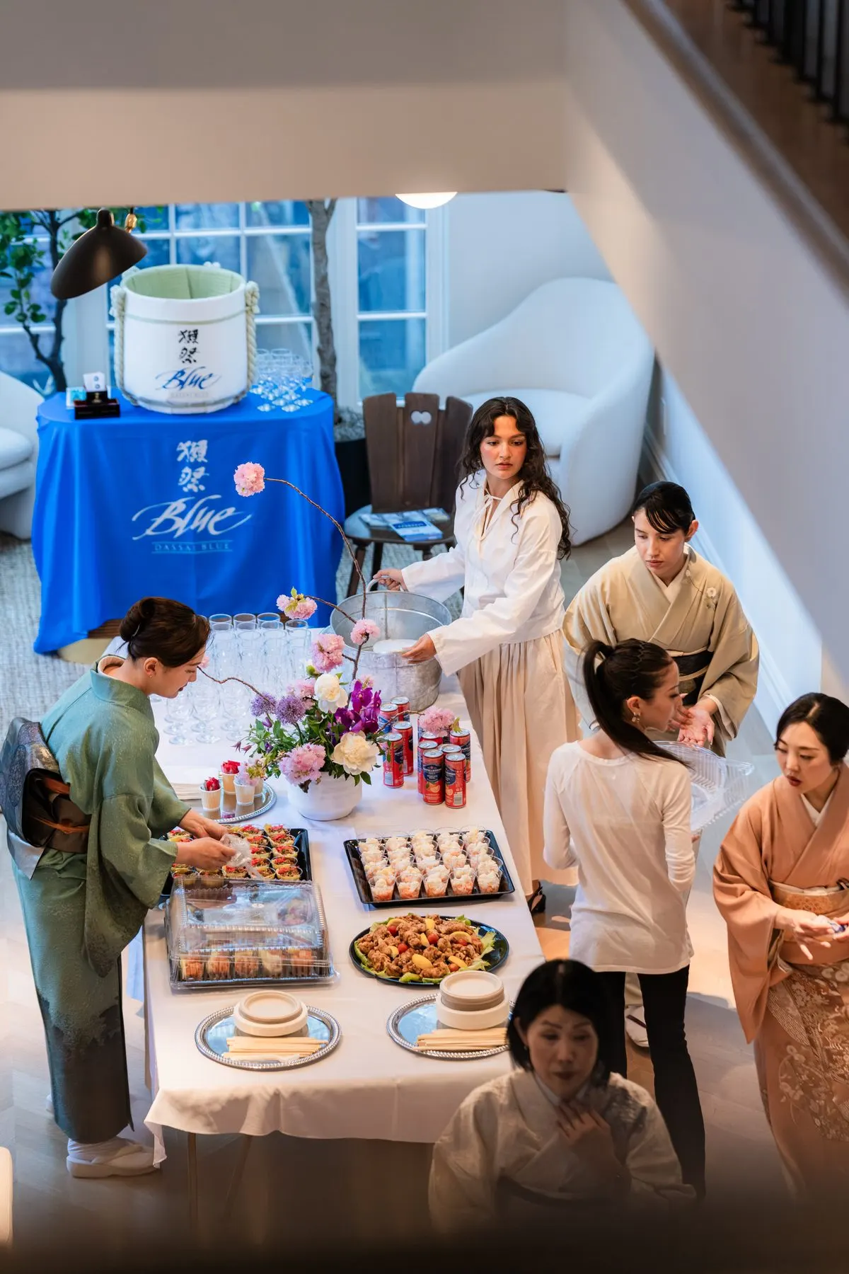 From above: hosts setting out the buffet by the Dassai Blue table