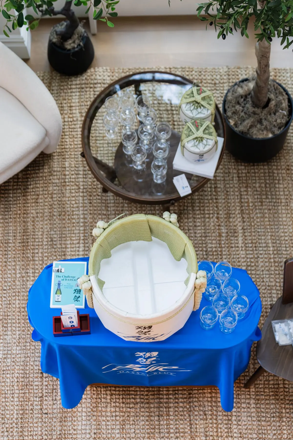 From above: the Dassai Blue table, a sake barrel and small glasses