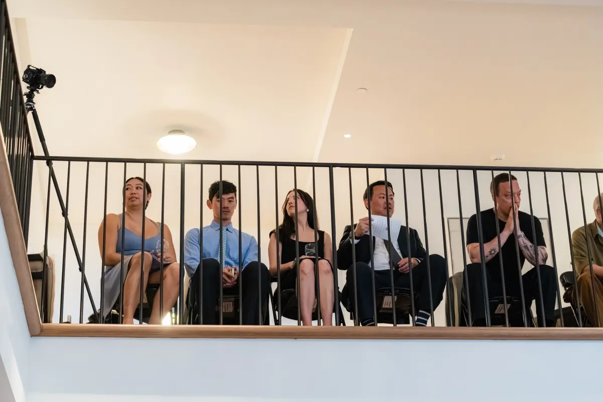 Guests listening from the balcony