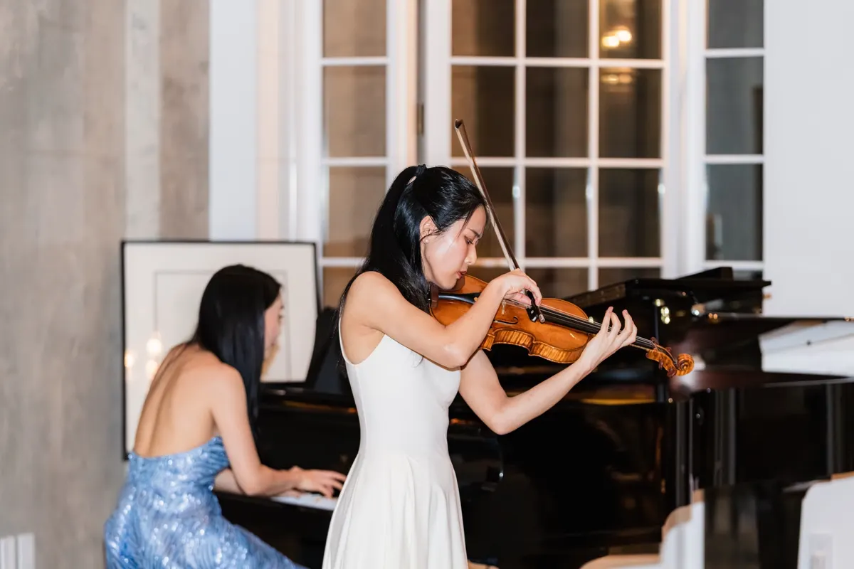 Violin and piano by the windows of the townhouse