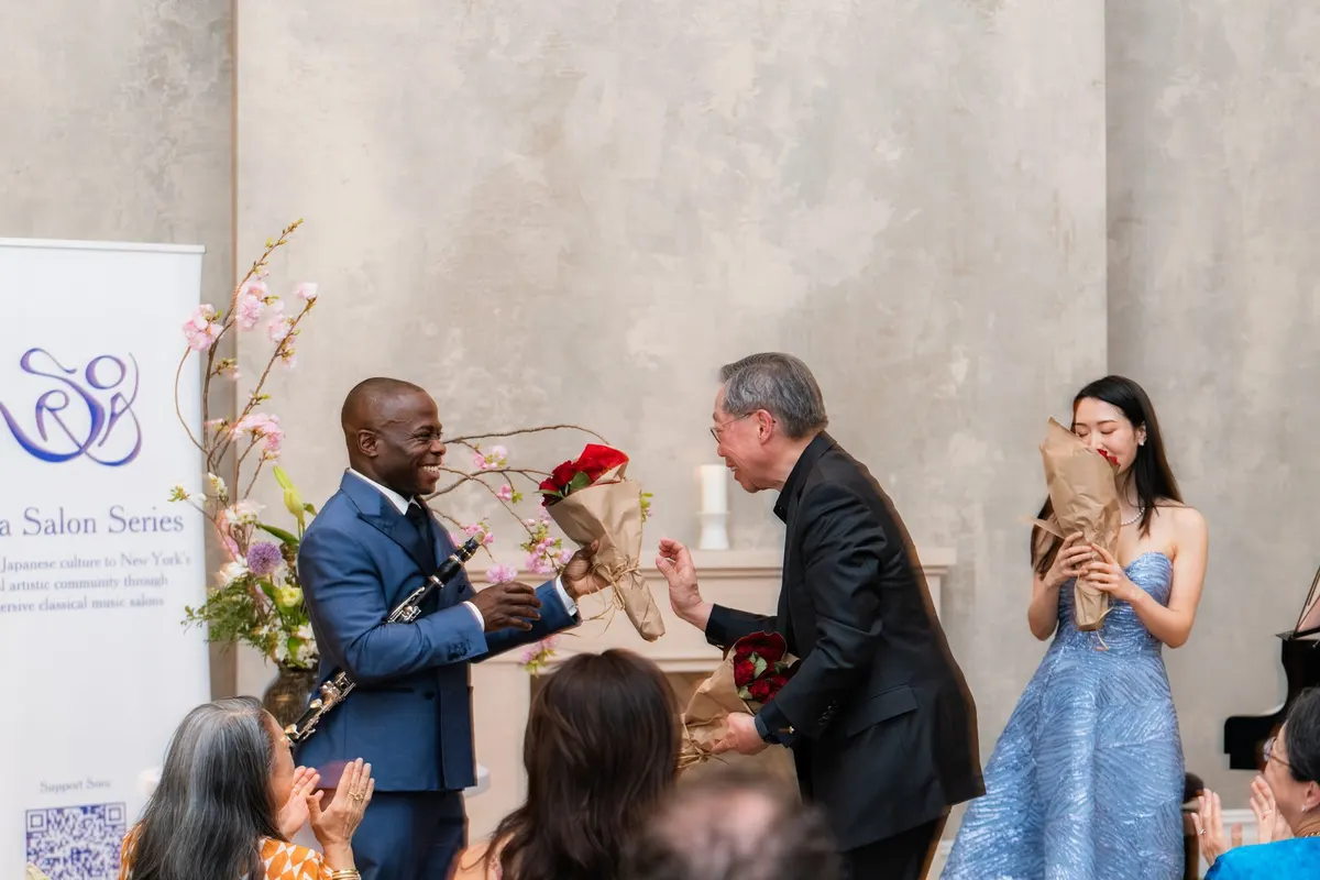 A guest giving Anthony red roses; Rieko holds hers