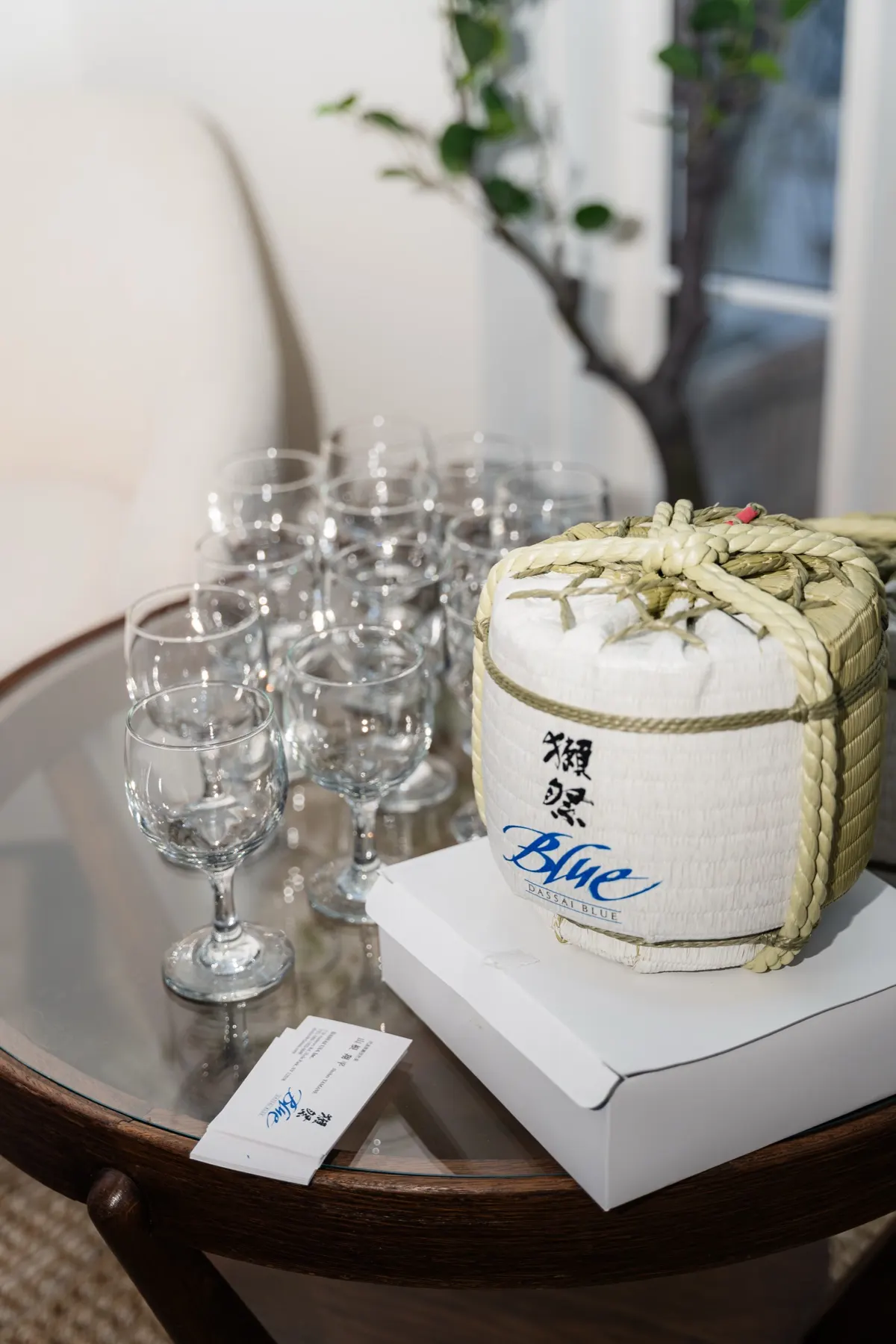 A Dassai Blue sake barrel and glasses
