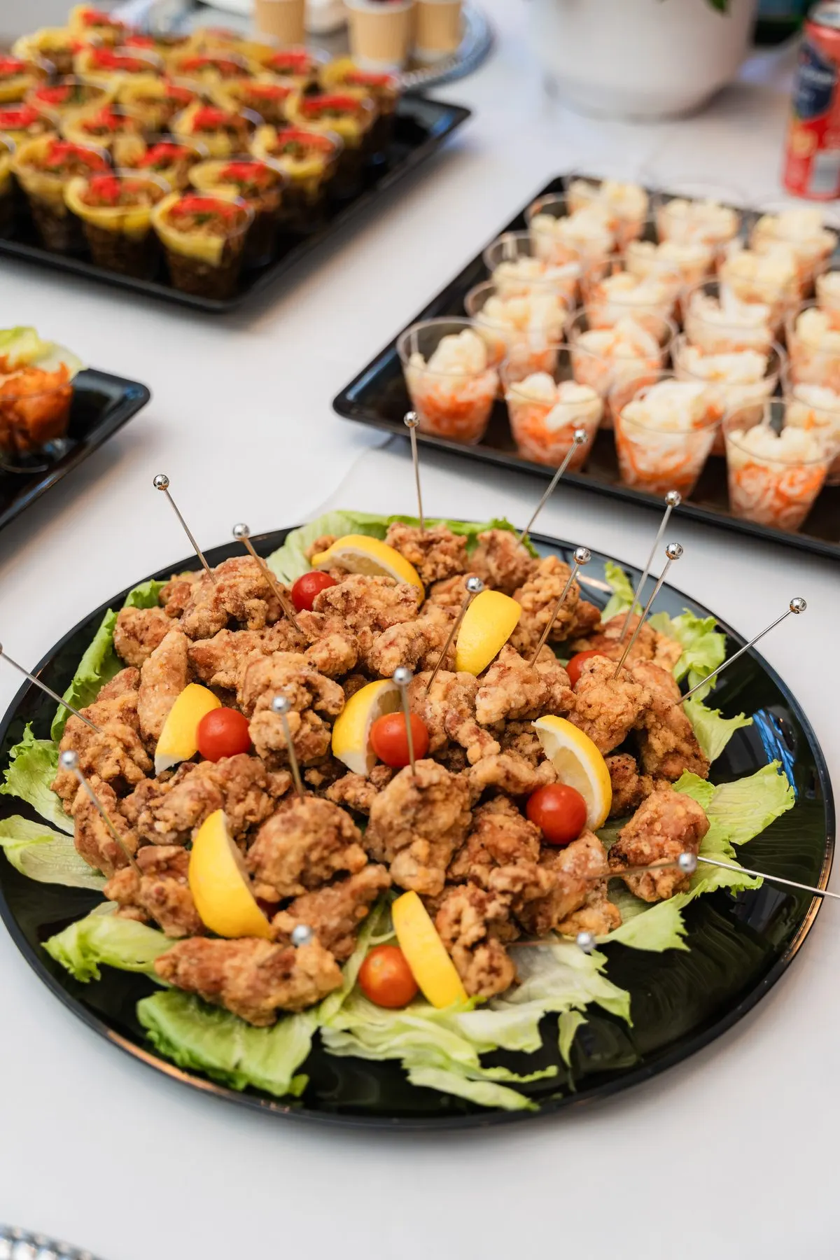 A platter of karaage, appetiser cups behind