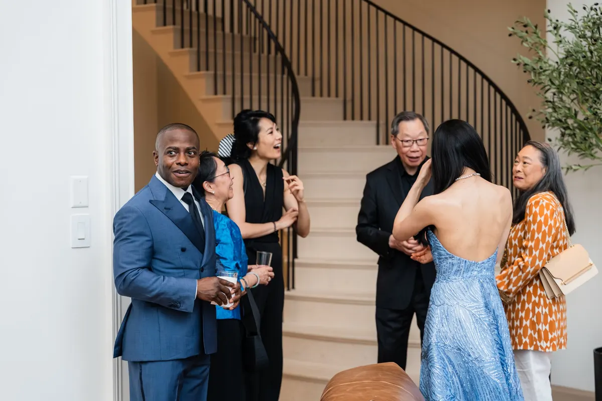 Guests talking by the staircase at the townhouse