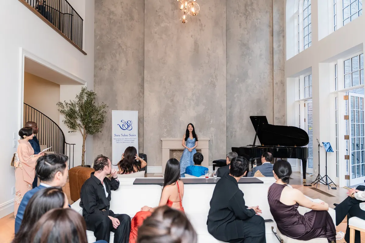 Guests seated around the piano in the townhouse